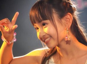 Yune doing a peace sign during a performance