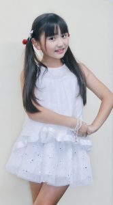 Yune posing in a white dress and twin tails